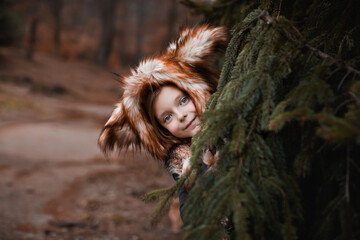 a girl dressed as a fox in a fox hat
