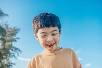 Happy Little Asian boy happy, Kid showing front teeth with big smile and laugh: funny smiley...