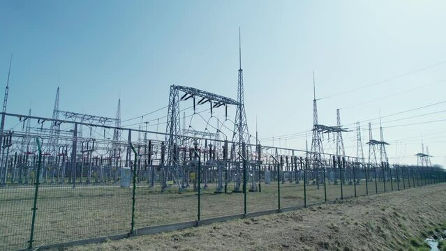 Transformer station, energy security of countries. A power station surrounded by barbed wire and monitored by industrial cameras.