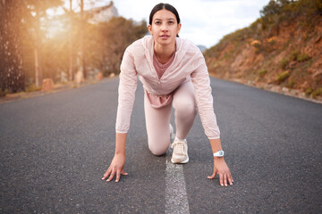 Youll be surprised at the limits your body can reach. Shot of a young woman in starting position while exercising outdoors.