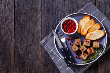 liver pate cubes on plate with toast and berries