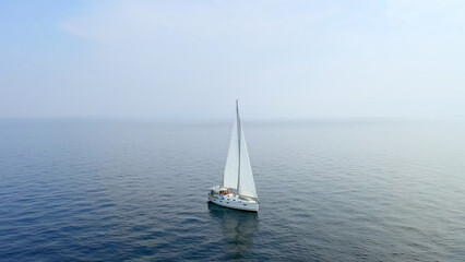 Obraz premium Sailing yacht in the sea. Beautiful aerial drone shot.
