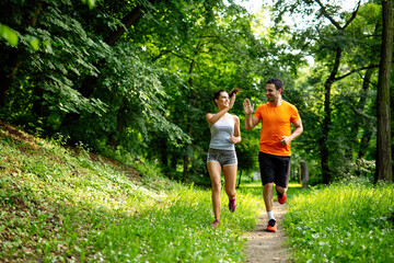 Portrait of happy fit people running together ourdoors. Couple sport healthy lifetsyle concept