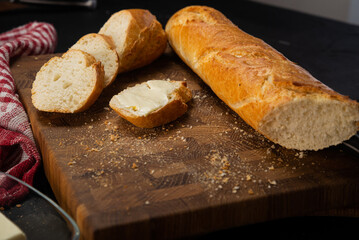 Fresh baguette. Sliced baguette with butter