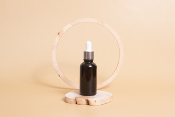 Wooden podium or pedestal with a dropper bottles of cosmetics oil or serum. Neutral beige monochrome skin care concept