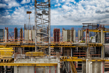 Monolithic frame construction of the building. Workers working at the construction site at home....