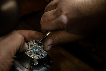 Different goldsmiths tools on the jewelry workplace. Jeweler at work in jewelry. Desktop for craft...