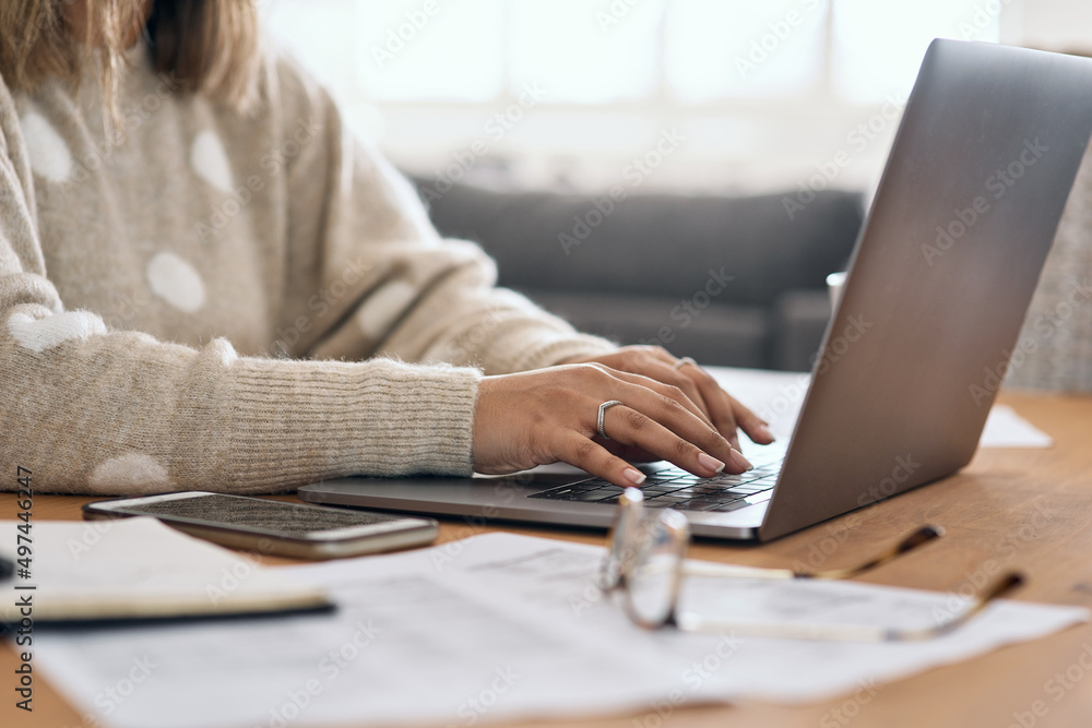 Poster working towards success one day at a time. cropped shot of a woman using her laptop while working fr
