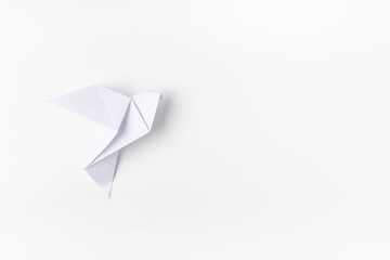 White dove origami as a symbol of peace on a white background