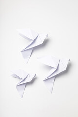 White dove origami as a symbol of peace on a white background