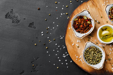 Oil, herbs and spices on wooden background