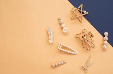 pattern of hair clips with pearls on color background
