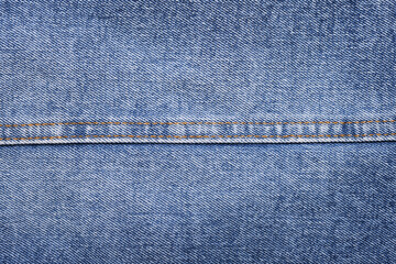 Blue jeans background and texture close up.Denim seam. 