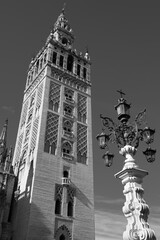 Tower of La Giralda and decorative street lantern. Seville, Spain.