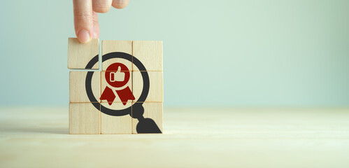 Quality warranty concept. Standardization, ISO. Hand placed wooden cubes with quality warranty icon on grey background.Used for banner and advertising premium product and service quality commitment.