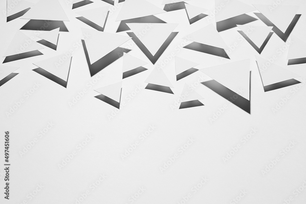 Poster white flying triangles geometric pattern in hard light with strict black shadows in random as border
