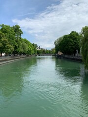 Fast flowing river with green trees. Taken in Munich Germany. 