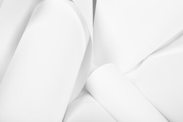 White sheets of office paper are twisted and scattered. Paper white abstract background.
