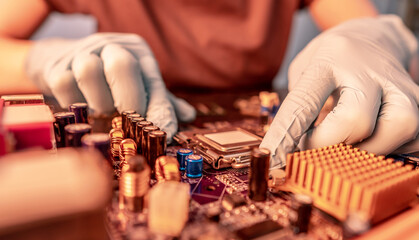 Engineer repairman holding hands CPU to insert into the socket of the motherboard. Technology...