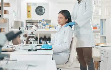 I just cant make a breakthrough with this case. Shot of a young scientist looking stressed out while being consoled by a colleague in a lab.