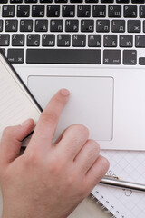 An office worker works on a laptop in the office.