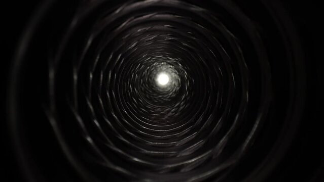 4K: Light at the end of the tunnel. Travelling through a passage or tube to after life. Tracking motion with probe lens. Stock video clip footage