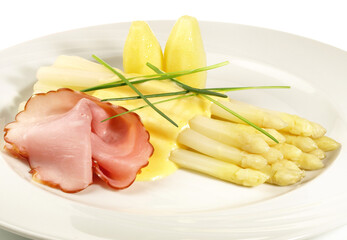 White Asparagus with Sauce Hollandaise, Farmer Ham and Potatoes isolated on white Background