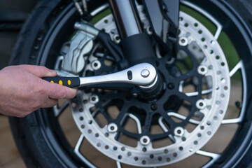 A service worker repairing a motorcycle at the service center