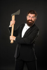 Aggressive bearded man threatening with axe dark background, aggression