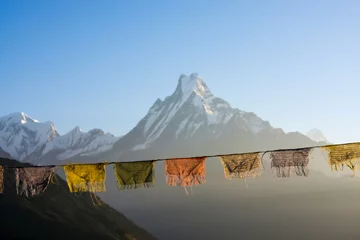 No drill light filtering roller blinds Annapurna Buddhist prayer flags illuminated by rising sun in front of blurred Machapuchare mountain background in Nepal. View of the Fish Tail Machapuchare from the Tatopani village.