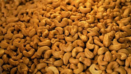 Lots of cashews sprinkled with salt background, cashew nut texture background.