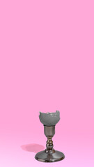 Creative Easter concept. Egg shell on metal stand on pastel  pink background. Minimal Easter concept