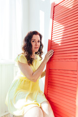 beautiful woman in a yellow summer dress