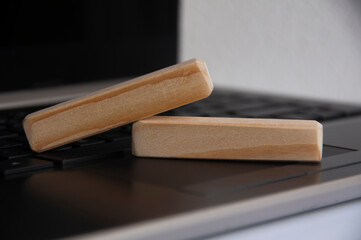 Blank wooden blocks on top of a laptop. Copy space concept