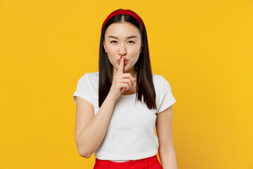 Secret young woman of Asian ethnicity 20s years old wears white t-shirt say hush be quiet with...