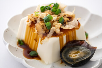 Delicious Chilled tofu and century egg with soy sauce and bonito flakes.