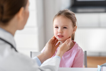 medicine, healthcare and pediatry concept - female doctor or pediatrician checking little girl...