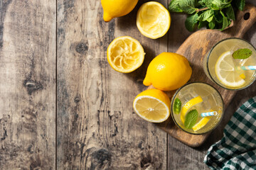 Glass of fresh lemonade on wooden table.Top view.Copy space