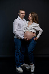 studio portraits of a couple expecting a baby
