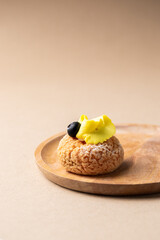 Modern sweet puffs - French choux pastry (eclairs) with lemon cream and blueberries