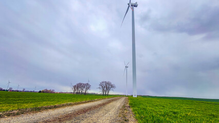 Fototapeta na wymiar Electric wind turbine generating with blue sky and turbo generator