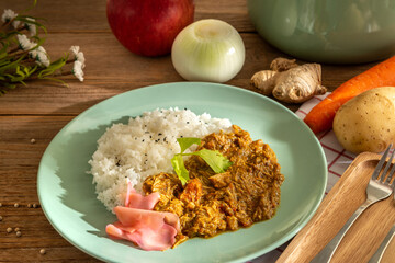 Japanese style curry over rice top with black sesame dish menu serve with ginger's pickle on wooden table background. Eatable health food main course dinner recipe local international herb concept