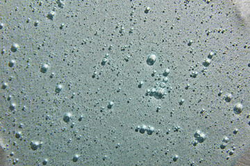 Blue cream liquid gel serum on silver texture, makeup and cosmetics background, skincare or hair product