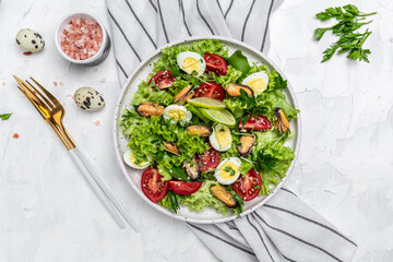Fresh salad with mussels, quail, egg, conjugate, lime, spinach, lettuce, cherry tomatoes and microgreen on a light background. Dietary salad. banner, menu, recipe place for text, top view