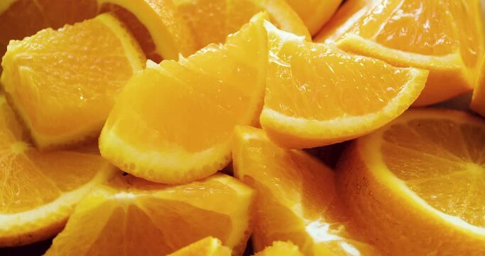 Close-up of juicy ripe orange slices on a large plate.