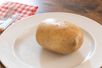 potato with skin on a white plate