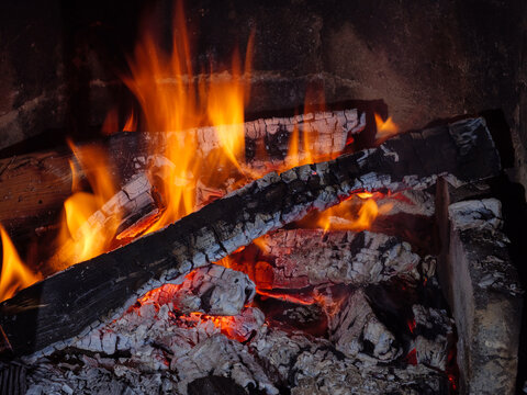 Flame of smoldering and burning coal in the fireplace