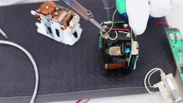 Man hold tool repairs electronics manufacturing Services, Manual Assembly Of Circuit Board Soldering.