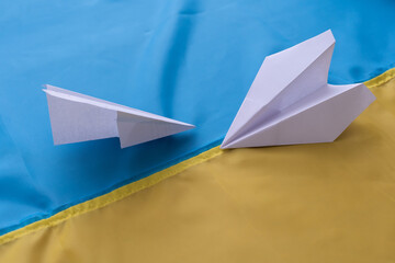 Two paper airplanes with the flag of Ukraine. Handmade arts concept
