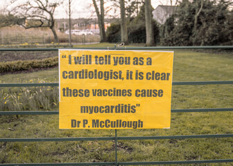 Protest Sign: Vaccine protest sign, by a green space.